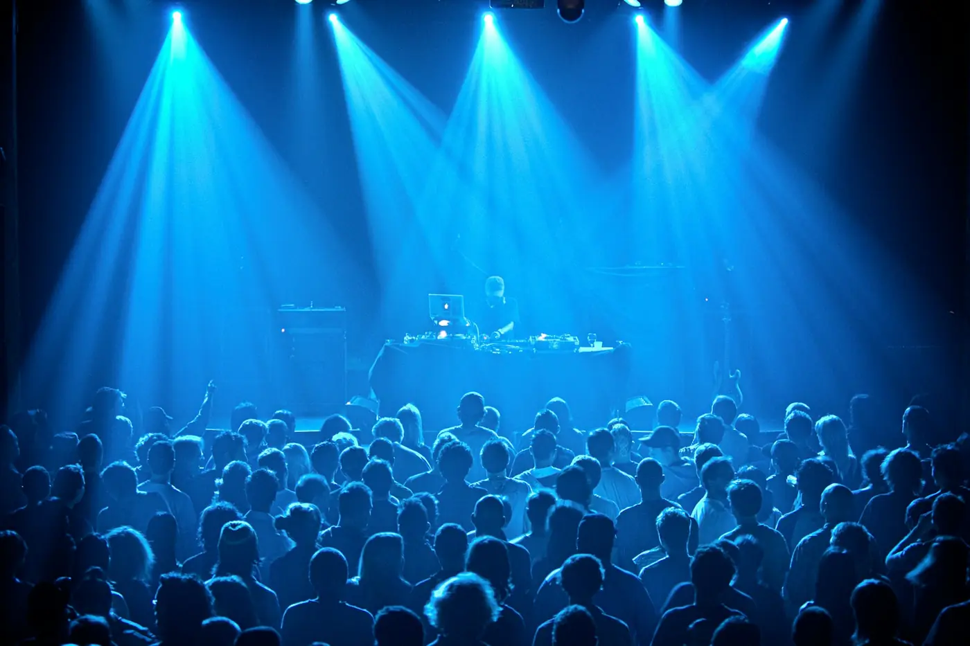 Stage lighting washing over an audience