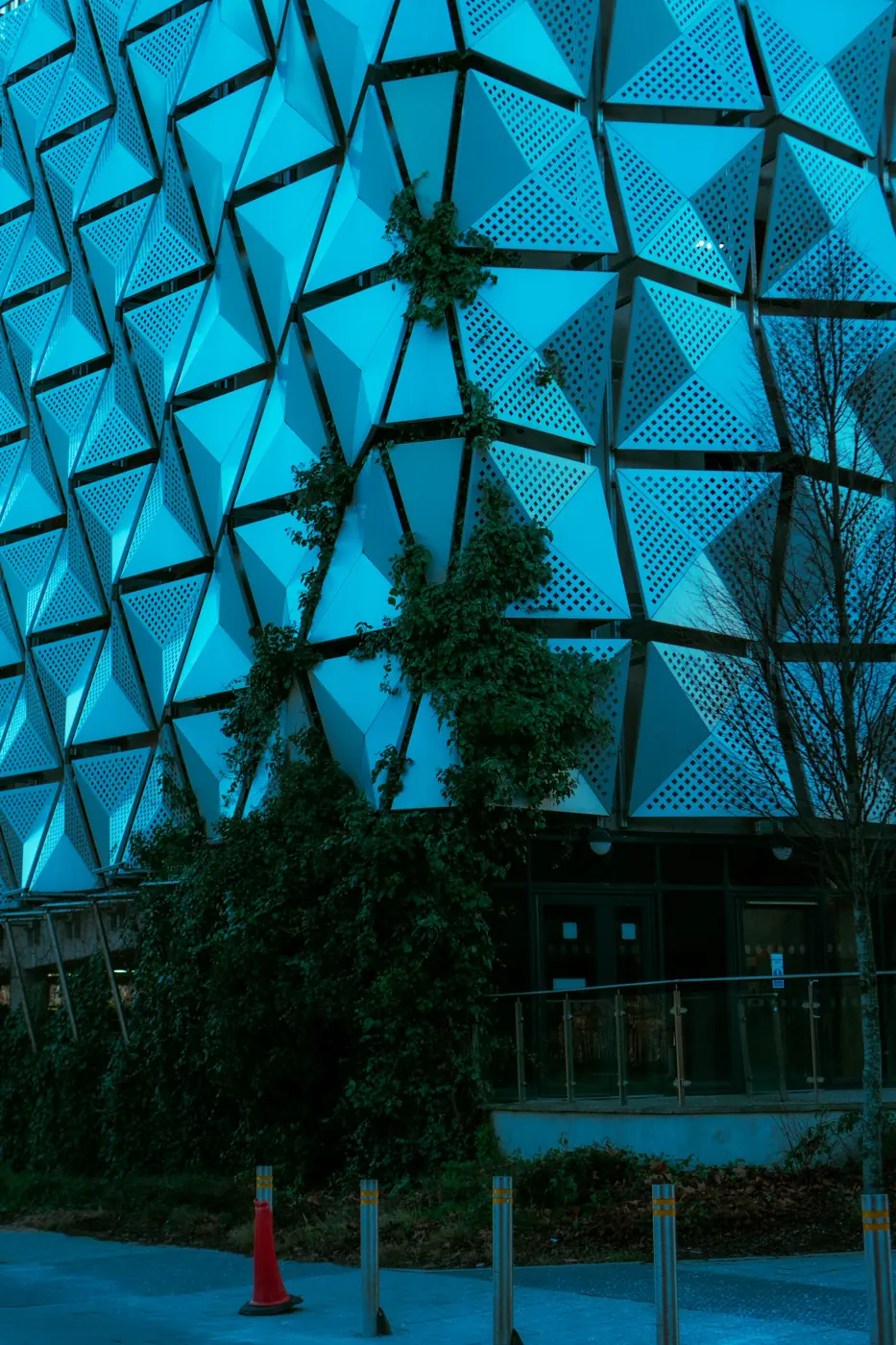 Glass facade lit in cyan