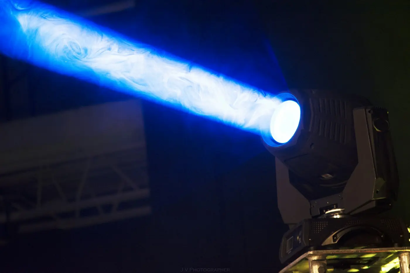 Moving head throwing a blue beam